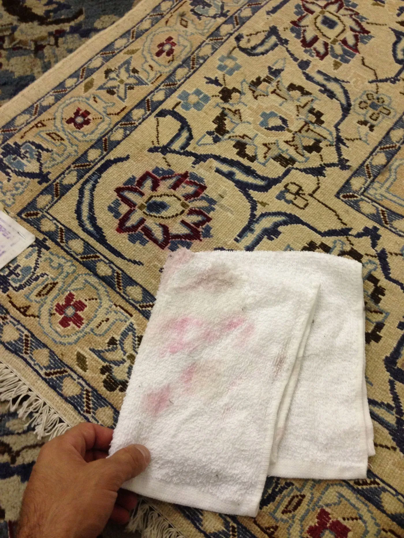 Hand spot treatment on an Oriental rug