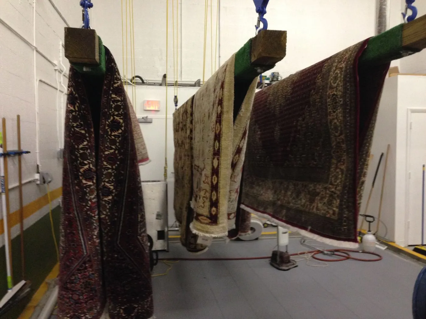 Customer rugs on the drying racks at our Miami Beach shop
