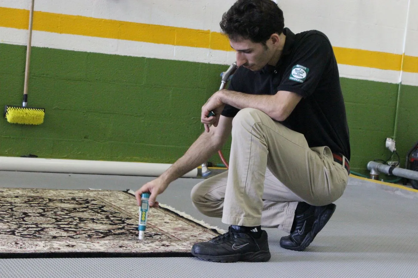 Technician inspecting an Oriental rug on the wash floor of our Miami Beach shop